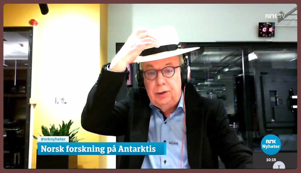 Man using a hat to describe Antarctic ice shelves.